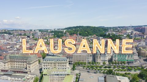 Inscription on video. Lausanne, Switzerland. Flight over the central part of the city. La Cite is a district historical centre. Heat burns text, Aerial View