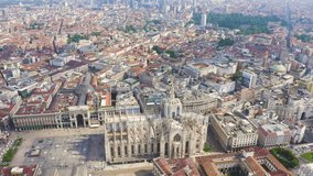 Inscription on video. Milan, Italy. Roofs of the city aerial view. Spiers Milan Cathedral. Cloudy weather.. Appears from the sand, Aerial View