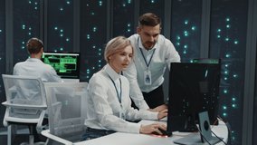Couple of caucasian male female IT specialists operating in server room. IT administrator with office assistant cloud computing programming code. - Powered by Shutterstock - Get 15% off with code: PIKWIZARD15