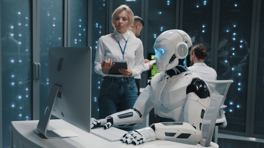 Humans and robots. Cybernetic future worker automated robot programming computer data cooperating with people colleagues. Artificial intelligence. Data center.