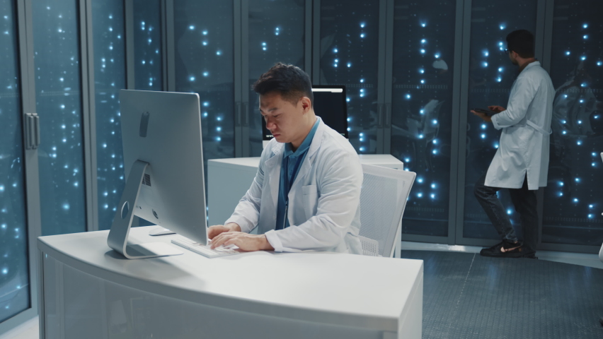 Japanese IT technical specialist using computer desktop typing server data monitoring cloud computing backup operation programming in data center office. - Powered by Shutterstock - Get 15% off with code: PIKWIZARD15