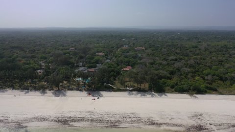 Diani beach Kenyan coast African Sea drone aerial 4k waves blue indan ocean tropical mombasa turquoise white sand East Africa palms paradise hotel view diani sea sesort lodge Kenya landscape 