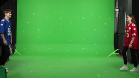 Young couple greeting and dancing on a green screen background. A guy and a girl in love make making content . Modern bloggers are creating a master class. Chroma key