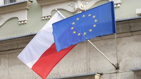 Flags of Poland and the European Union, Polish flag and UE flag together, object closeup, nobody, slow motion. NATO countries alliance protection political treaty symbol abstract concept, no people - Powered by Shutterstock - Get 15% off with code: PIKWIZARD15