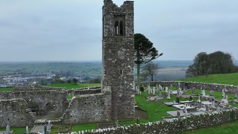 Hill of Slane, County Meath, Ireland, January 2022. Drone orbits the ruined friary church tower at a lower altitude from the north.