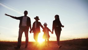 people in the park. friendly family silhouette walk at sunset. mom dad and daughters walk holding hands in the park. happy family kid dream concept. parents and fun children walking back silhouette - Powered by Shutterstock - Get 15% off with code: PIKWIZARD15