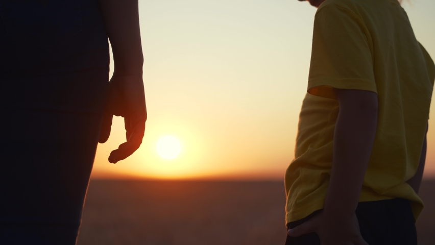 happy family. mom and daughter hold hands a close-up teamwork. mother and girl kid together hands at sunset. parent girl and child happy childhood. daughter happy family fun mother day concept Royalty-Free Stock Footage #1087764689