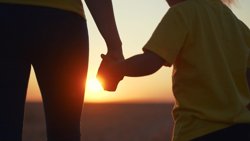 happy family mom and daughter hold hands a close-up teamwork. mother and girl kid together hands at sunset. parent girl and child happy childhood. daughter happy family fun mother day concept Royalty-Free Stock Footage #1087764689