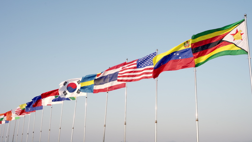 Many international flags wave outdoors for sporting events, the symbol represents harmony.