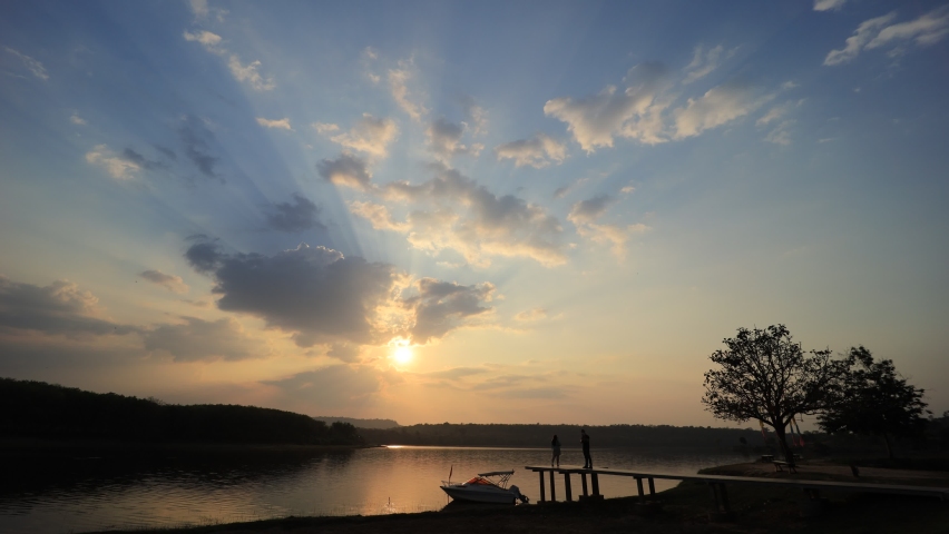 Time-lapse photography of evening sky, red, orange, yellow clouds over the river