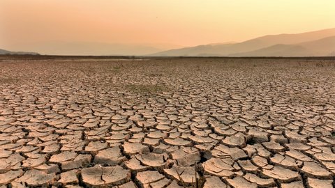 Drought and climate change, Landscape of cracked earth with orange sky after Lake drying on summer. Water crisis an impact of global warming. Adlı Stok Video