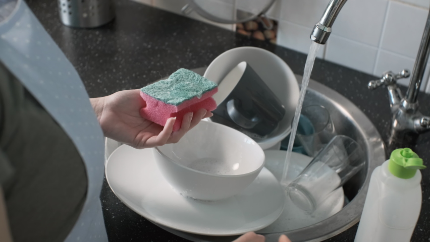 Closeup of Female Hands Washing Dishes in Kitchen Sink. Slow Motion. Domestic Housework and Housekeeping Concept | Shutterstock HD Video #1087772216