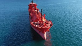 Aerial drone video of industrial LPG gas tanker ship anchored in Mediterranean deep blue sea