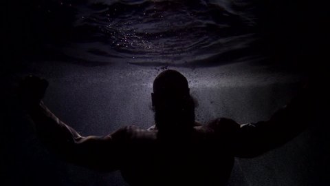 dark silhouette of Poseidon inside water of ocean or sea, mysterious secret of underwater world