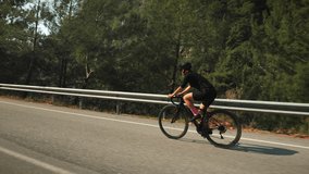 Cyclist training on bicycle, pushing pedals. Athlete Workout. Sport recreation healthy lifestyle. Cyclist on bike doing endurance exercising. Woman riding bicycle in mountains. Sport concept