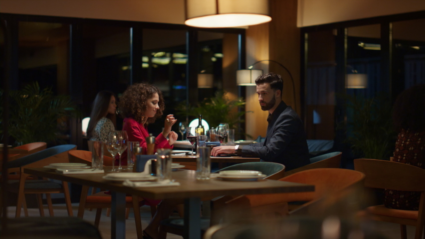Couple paying restaurant bill in fancy night restaurant. Waiter serving customers in cafe. Two love partners enjoy food meal in bar together. Lovers sharing dinner on romantic date. Going out concept Royalty-Free Stock Footage #1087774520