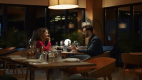 Waiter serving hungry couple in fancy restaurant. Man putting plates on cafe table. Two lovers enjoy fine dinner date in luxury place. Romantic partners eating delicious culinary meal. Dining concept. - Powered by Shutterstock - Get 15% off with code: PIKWIZARD15