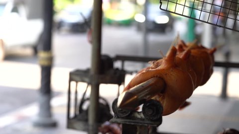 Whole carcass duck roasting in the Street of An Asian Capital - static