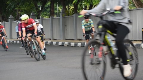 Pulo Mas Jakarta, Indonesia - March 03, 2022: A group of people pumping adrenaline by racing bicycles on the highway.