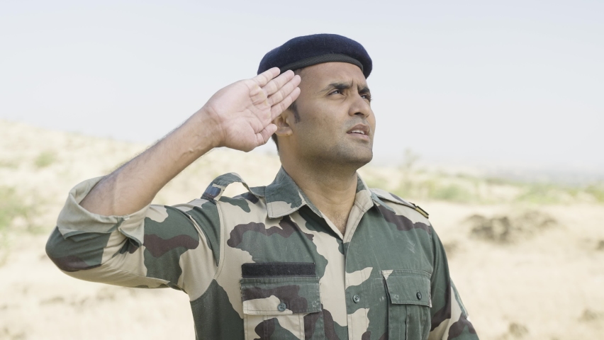Proud Indian army soldier saluting by looking above - concept of patriotic, respect and honour