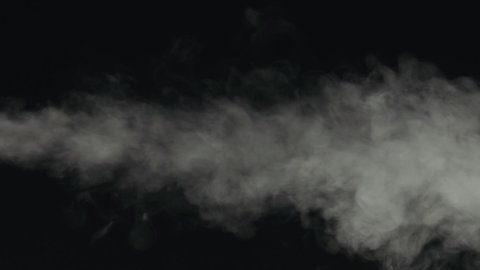 Slow motion water mist puff stream over black background