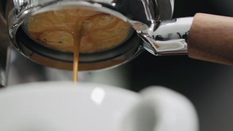 low angle shot of espresso extraction with bottomless portafilter