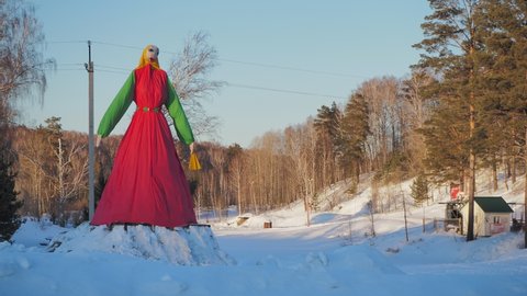 Maslenitsa holiday. A huge figure symbolizing winter and intended for burning as a symbol of the past winter. Siberia. Hand held.
