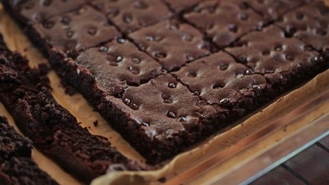 Dolly shot of Baked dark chocolate chip brownies in tray 