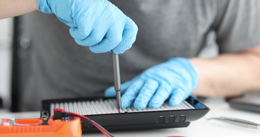 Male repairman repairing lighting equipment closeup