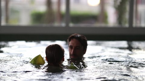 Father and son at swimming pool. dad holding baby toddler boy
