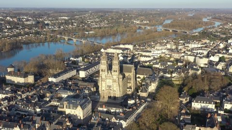 France, Tours city, Saint-Gatien cathedral during sunset (or sunrise) with Loire river in back. Drone aerial view.