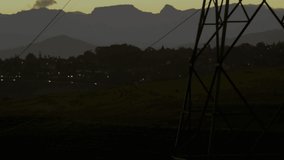 Animation of data processing and moving shapes over landscape with electricity pylons. global connections, technology, data processing and digital interface concept digitally generated video.