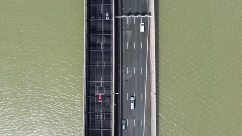 Aerial top down view moving over road tunnel going underwater traffic moving in both ways located in Holland which is well known for its innovative water management and infrastructure solutions 4k