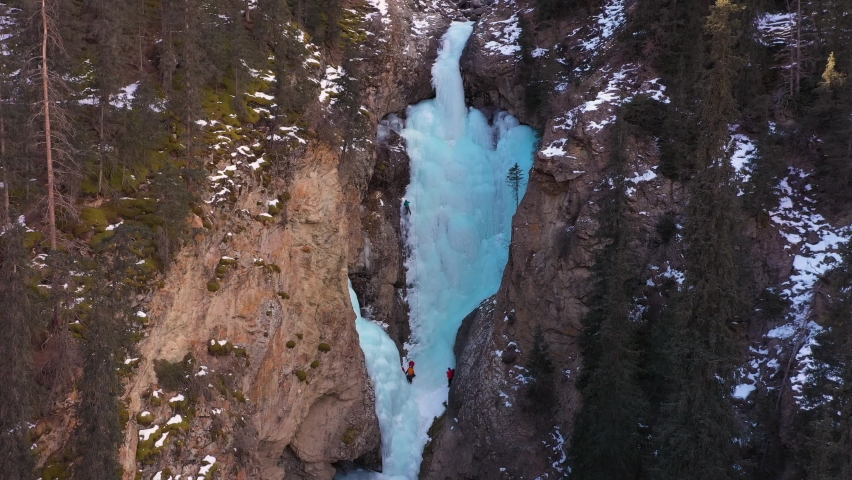 Ice Climbing on Frozen Waterfall, Aerial View. Barskoon Valley, Kyrgyzstan. Drone Flies Forward