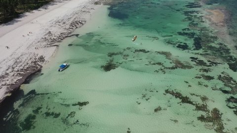 wind kite surfing boats yachts on water sea Drone view Coastline Diani beach landscape Kenyan African Sea  aerial 4k waves indan ocean tropical mombasa turquoise white sand East Africa palms paradise