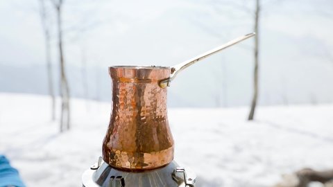 Making coffee in Cezve at winter mountains