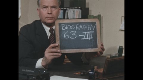 1960s: Man holding slate. Man sitting at desk, reading paper, shaking head. Text on chalkboard. Book cover. Hand turning pages in book, pointing at page.