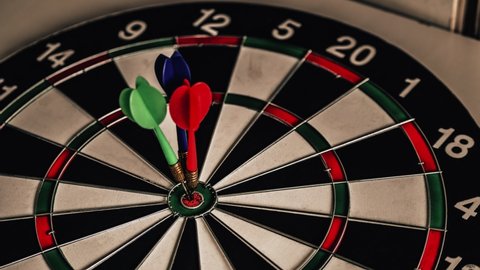 Conceptual of challenge in business marketing bullseye and intelligent customer reaching. The dart is the strategy or skill. The dartboard is the target or goal.
