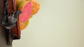 Vertical video of a hand leaving a colombian tropical candy made of guava called bocadillo on black wooden table 