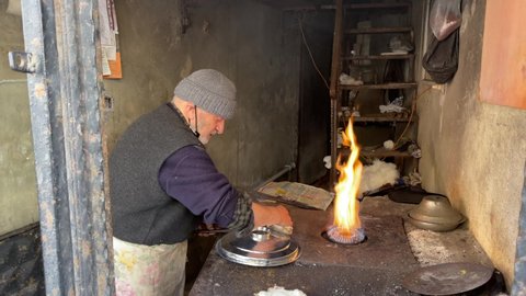 ISTANBUL - TURKEY - 15.02.2022.old man Cooking Pot Lid making Tin 4K video shooting old Style doing it by hand wonderful natural image buying now. 