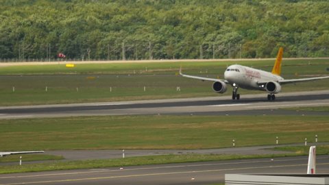 DUSSELDORF, GERMANY - JULY 23, 2017: PassengeAirbus A320 Fly Pegasus landing in Dusseldorf, slow motion. Tourism and travel concept. View of the airfield summer day