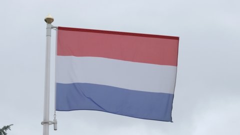 Ungraded: National flag of Netherlands on the flagpole. Dutch official flag waving in the wind. Ungraded H.264 from camera without re-encoding.