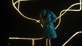 a man from the future interacts and dances against the background, of an LED screen with abstract generated image, art digital