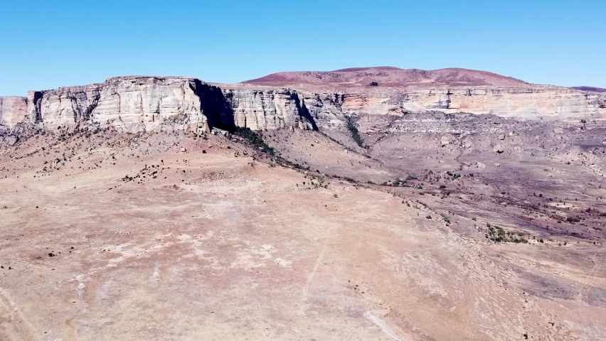Aerial drone shot ascending up revealing the beautiful sandstone mountains of the Drakensberg on a beautiful sunny day, KwaZulu Natal, South Africa