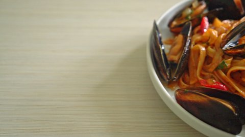 Spaghetti pasta with mussels or clams and tomato sauce - Italian food style