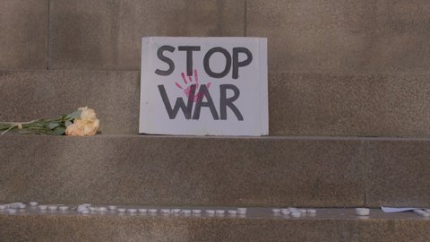 Stop War poster with baby handprint, flowers, candles in support of Ukraine during demonstration against the military invasion in Ukraine. 02.03.2022 Vaclavske nam., Prague, CZ 