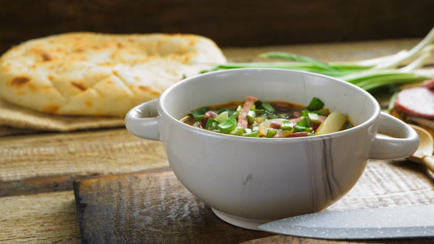 jewish cuisine bean soup cholit in the background bread and green onions