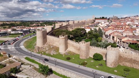 Avila , Spain - 06 19 2021: Avila, Castile and León, Spain - Aerial view of the City Walls, Cathedral and Driving Cars