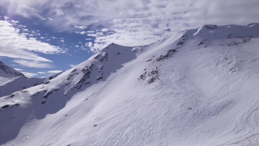 Flying Towards a Mountain Ridge in the Snowy Alps - Dolly In Shot - Shot in Tignes and Val d