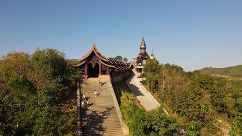 Phu Ruea , Loei , Thailand - 01 03 2022: Aerial footage of people climbing up and down the stairs of the famous Wat Somdet Phu Ruea, Ming Mueang, Loei in Thailand.